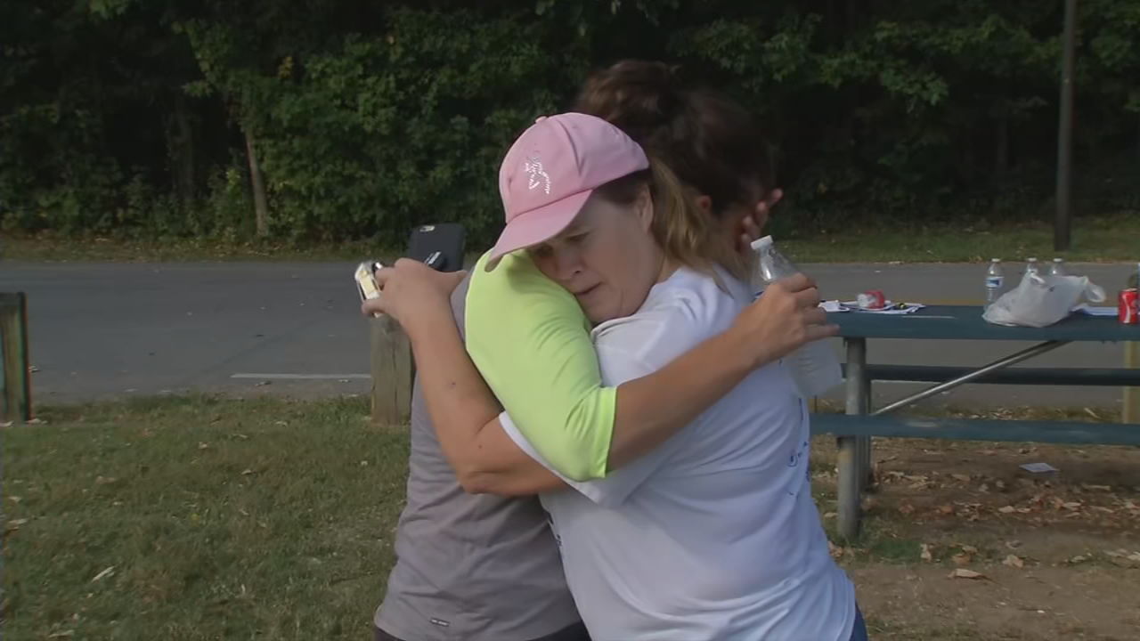Searchers embrace while looking for missing mom Andrea Knabel in Iroquois Park area Sept. 11, 2019